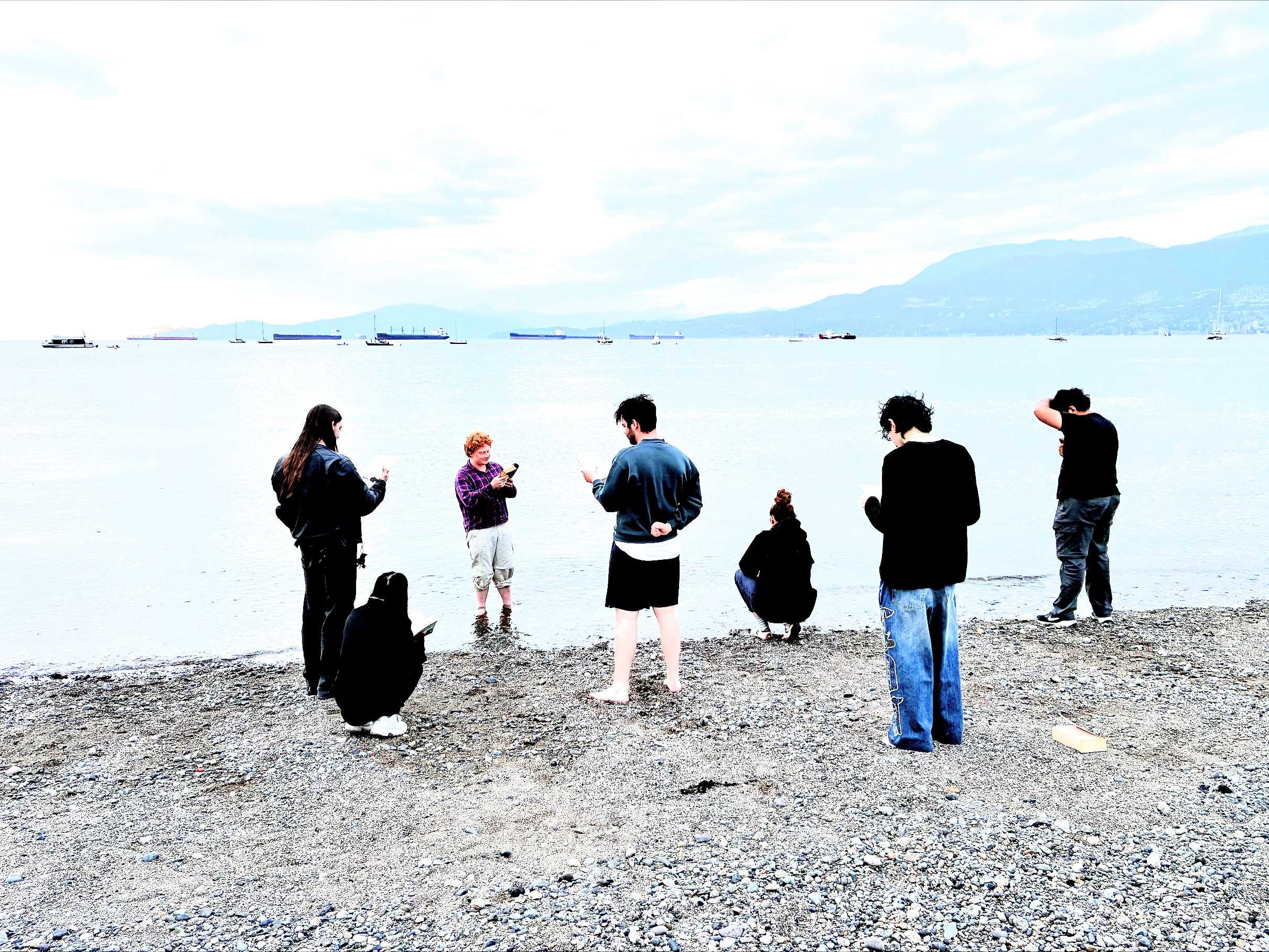 Members of the TURSCRDAJJMMU on the beach reading Ulysses
